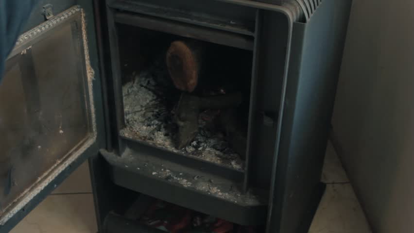 Having a cigarrette in fron of the fireplace