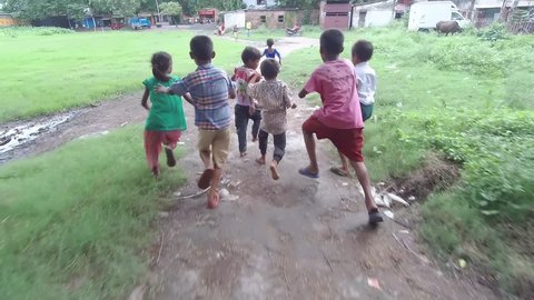 Kolkata, West Bengal / India - 08 20 2018: Poor little innocent Indian homeless children play and laugh