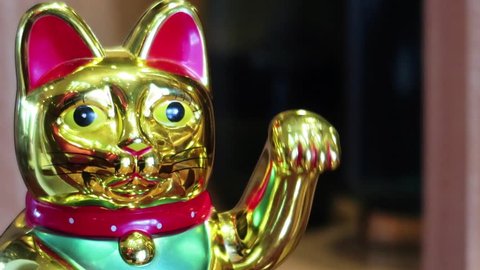 a close up shot of a maneki nekoh. Shot is taken on 60 fps and edited in 30 fps. footage is slowed by 50%.