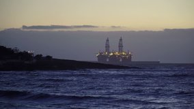 Offshore Oil Rig Drilling Platform in the ocean at the dusk. 4K Video Clip
