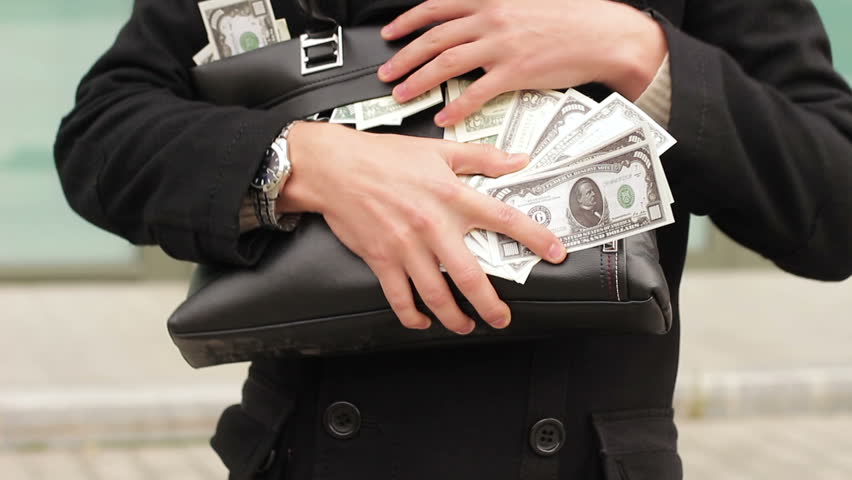 Man holding a bag full of money. Concept of greed, win and wealth Royalty-Free Stock Footage #1018667605
