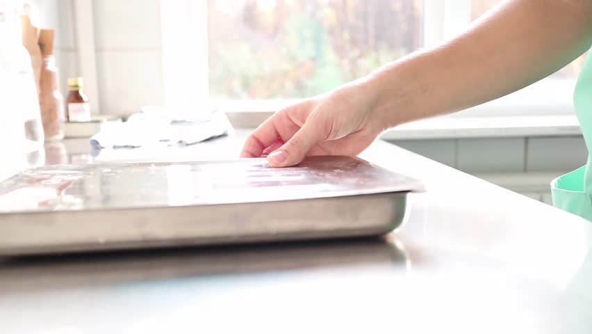 doctor wears medical gloves, wipes them, preparing for surgery
