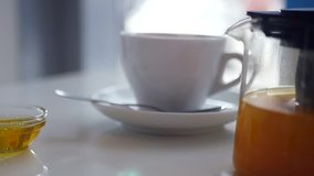 Drink invigorating hot tea in a white cup with steam. slow motion, 1920x1080, full hd