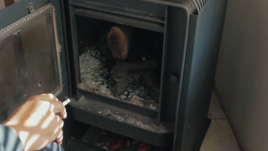 Having a cigarrette in fron of the fireplace