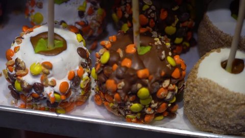 Toffee apples, also known as candy apples in North America, are whole apples covered in a hard toffee, chocolate and/or sugar candy coating with a stick inserted as a handle.