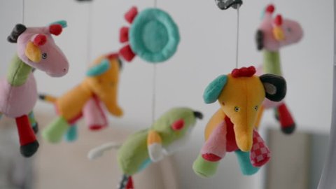 Carousel of children's soft colored toys.