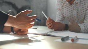 Two young men discuss the project plan. Drawing on white background, hands close-up. 4K - Powered by Shutterstock - Get 15% off with code: PIKWIZARD15