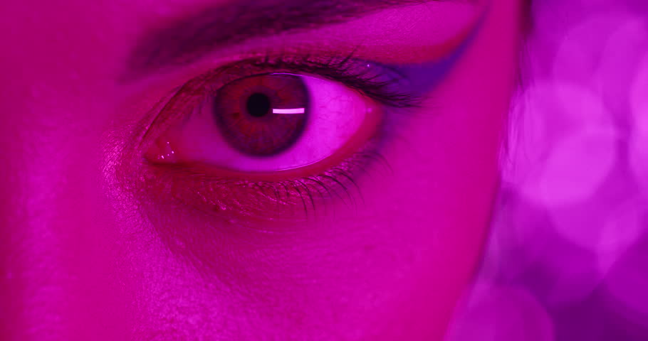 Close up macro eye woman wearing colorful makeup eyeshadow multicolor light flashing in club concept | Shutterstock HD Video #1018690402