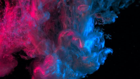 Pink and blue glitter ink in water shooting with high speed camera. Paint dropped, reacting, creating abstract cloud formations metamorphosis on black. Art backgrounds. : vidéo de stock