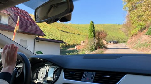 DURBACH, GERMANY - CIRCA 2018: Woman driving car in vines fields in Durbach a few meters from Burg Staufenberg castle, Baden-Wurttemberg, Germany