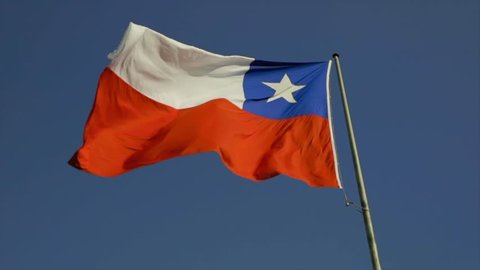 Beautiful shot of a Chilean flag in slow motion floating on a summer day with a blue sky background