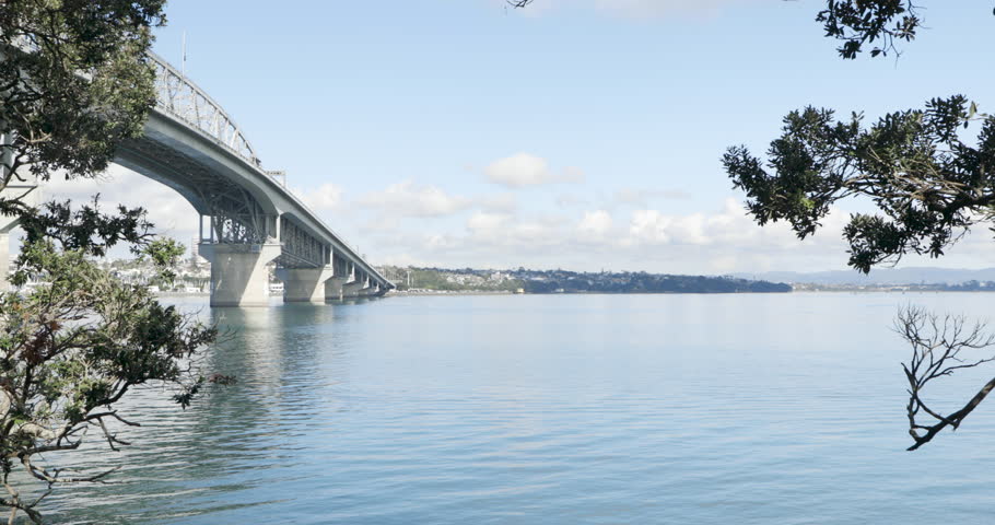 View of Auckland Harbour Bridge with ferry passing