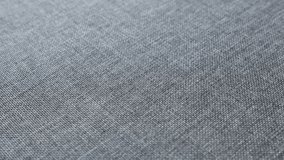 Dark grey upholstery fabrics surface slow tilt 4K footage