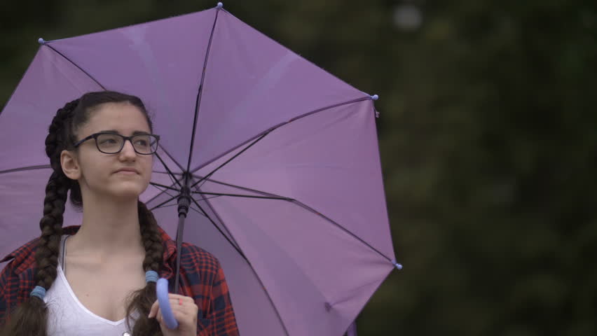 girl with an umbrella walking in the park, outdoors