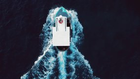 Video from above, aerial view of a beautiful fishing boat in the Mediterranean sea. Sardinia, Italy.