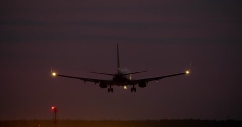 4K - Airplane landing at night on runway
