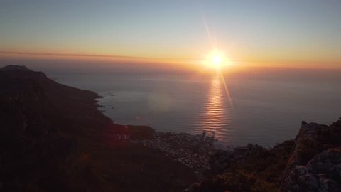 Person raises hand towards Sunset on Table Mountain in Cape Town, South Africa in Slow Motion