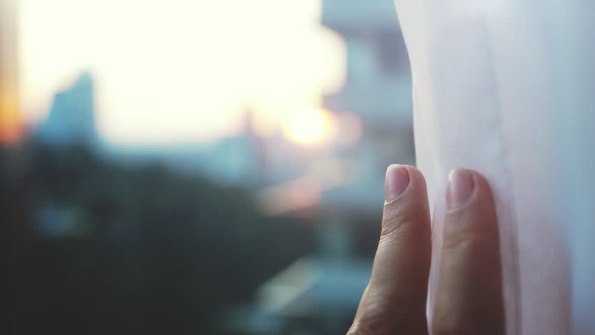 Female hand opens curtains with view on the city touching the sunlight by hand in her room at home. slow motion. 3840x2160 | Shutterstock HD Video #1018724995