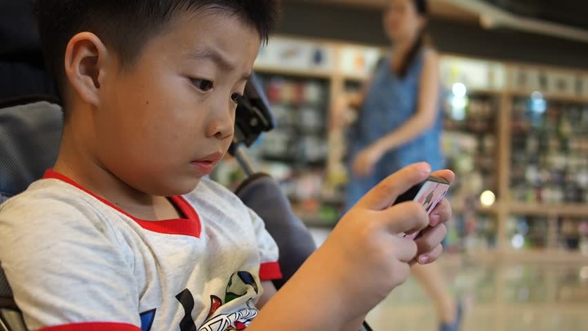 Asian Chinese Boy Playing Smartphone Stock Footage Video (100%  Royalty-free) 1018725763 | Shutterstock