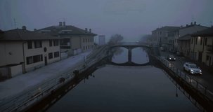 Aerial footage drone view of sunrise in navigli river skyline and boulevard in Milan, Italy // no video editing