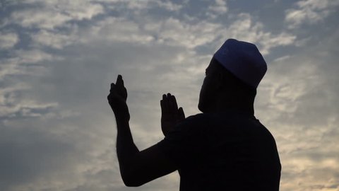 Young asian muslim man praying on sunset,Ramadan festival concept,Thailand people,Blessings from the Allah,	
