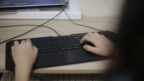 teenage boy playing a computer video game
