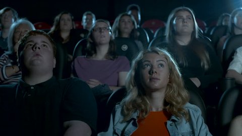 Young movie theatre crowd watching a film