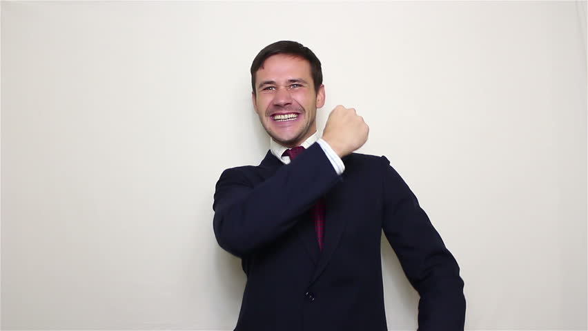 Handsome young businessman actively expresses joy clapping and loud laughing.Portrait on a white background. Royalty-Free Stock Footage #1018753330