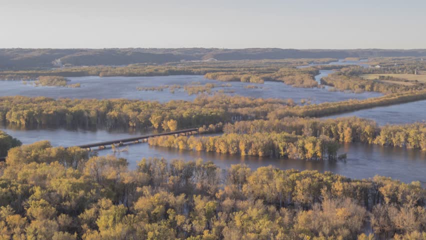 A Wide Angle Sunset Shot of the Wisconsin River Flowing into the Mighty Mississippi River with Freight Train Traffic during Fall in Wyalusing State Park 4K Timelapse