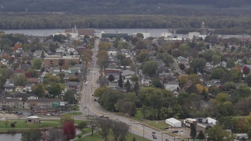 A Daytime Telephoto Shot of Street and Train Traffic through Rural Winona, Minnesota along the Mississippi River during Fall 4K Timelapse