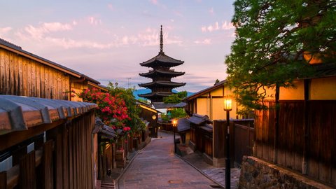 Kyoto, Japan. A sunrise timelapse with a view of To-ji temple and a row of old japanese shops and houses in Kyoto, Japan. Time-lapse, zoom in