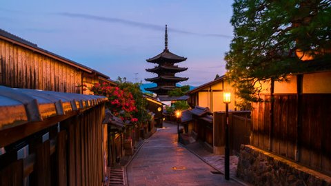Kyoto, Japan. A sunrise timelapse with a view of To-ji temple and a row of old japanese shops and houses in Kyoto, Japan. Time-lapse at sunrise