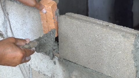 Bricklayer Mason or Building Room by Mortar or Cement. Semener is creating wall or room by brick. 4k 3840x2160 High resolution footage for industrial category