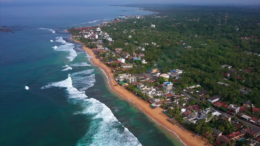 Aerial view of the town of Hikkaduwa stretched along the ocean coast, Sri Lanka