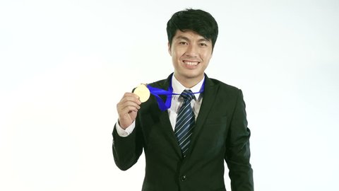 Businessman Holding Golden Medal And Smiling
