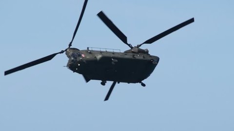 Chinook military helicopter flying in a sky agile moving.