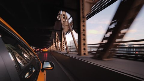 The famous New York yellow cab rides over the bridge. View from the taxi window