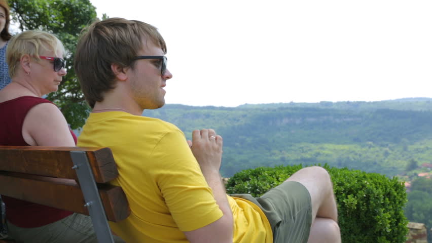 Group of tourist resting on bench