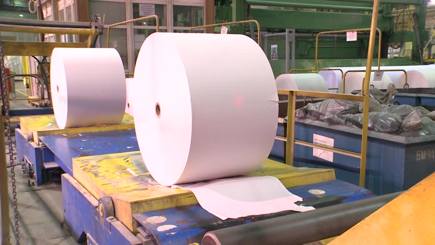 Paper production. White offset paper rolls moving on the conveyor belt. Filmed in Russia, Komi Republic, June 2017 25P / 1920x1080
