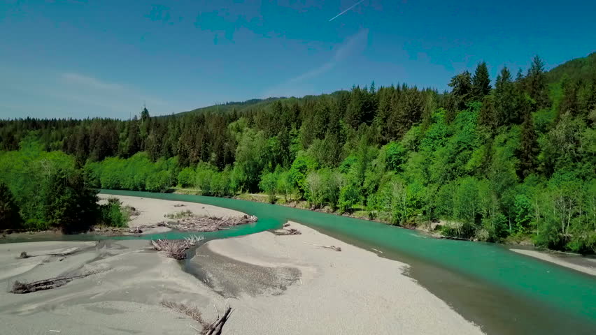 Aerial shot over the turquoise blue river of the Olympic National Park in Washington State