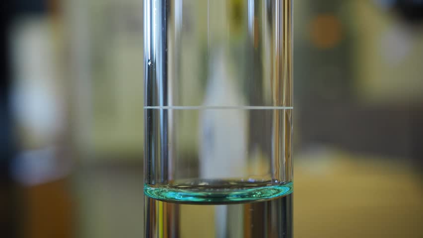 Filling the burette to the correct volume and showing the meniscus. Typical education and training technique. Royalty-Free Stock Footage #1018808509