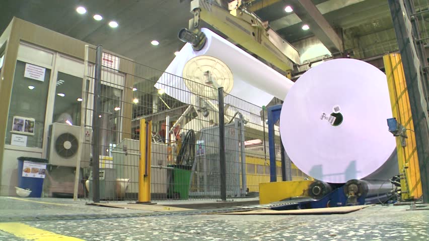 Paper production. Rolls of white offset paper are transferred by huge cranes for further cutting. Filmed in Russia, Komi Republic, June 2017, 25P / 1920x1080