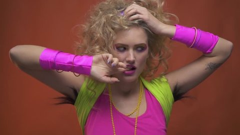 Woman with long armpit hair, in 80s style clothes, doing seductive moves