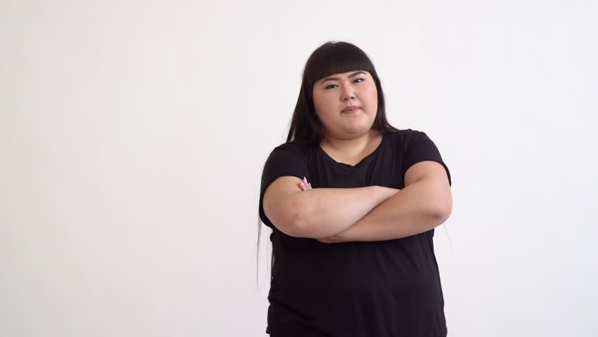 portrait of a fat beautiful Asian woman 20 years old, emotionally unhappy customer on white background in Studio Royalty-Free Stock Footage #1018824229