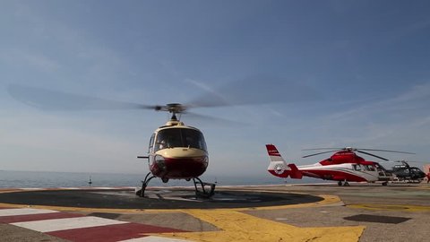 MONACO - FEBRUARY 13, 2018: A helicopter on the plat form above the sea in the Monte Carlo International Heliport. This heliport is the only aviation facility in the principality.