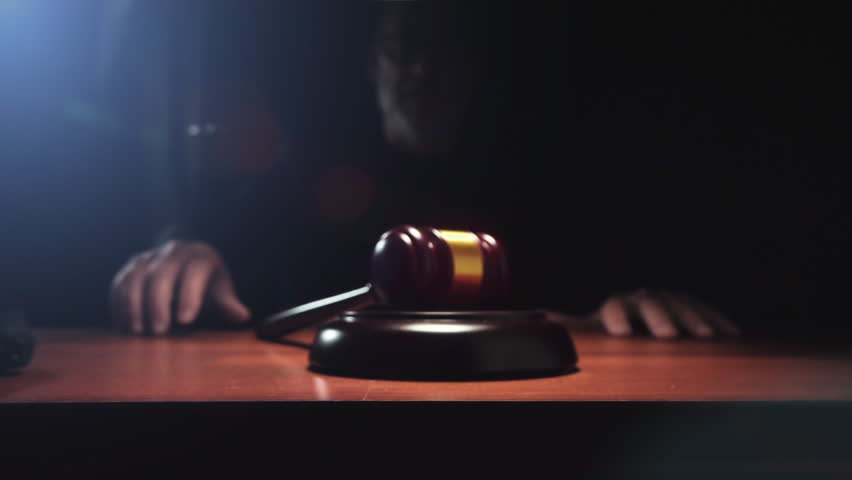 Judge hitting Gavel off a block in courtroom, dark background slow motion dolly shot Royalty-Free Stock Footage #1018835032