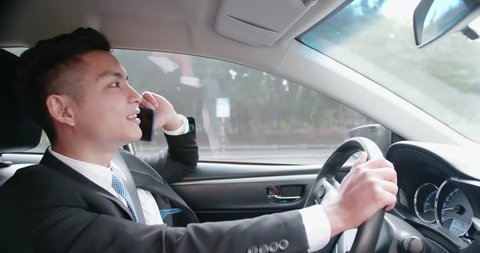 business man speak phone in the car while driving