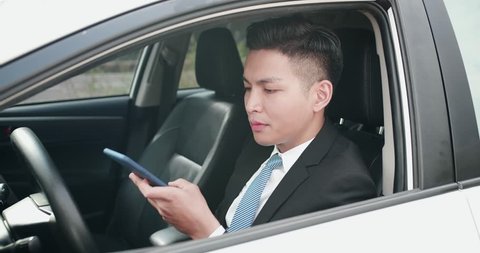 business man send audio message by smart phone in the car
