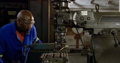 Attentive African-american metalsmith working in workshop 4k