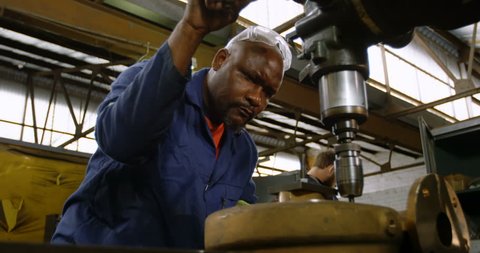 Attentive African-american metalsmith working in workshop 4k